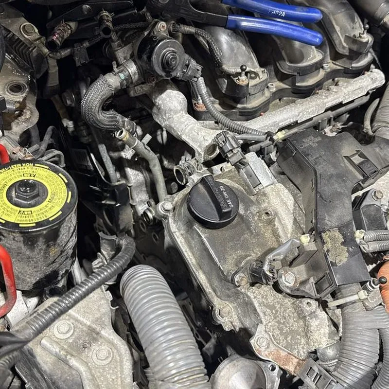 An engine bay opened up for repair on a Manko Mobile Automotive job.