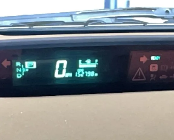 A Prius dash with the hybrid system warning lit.